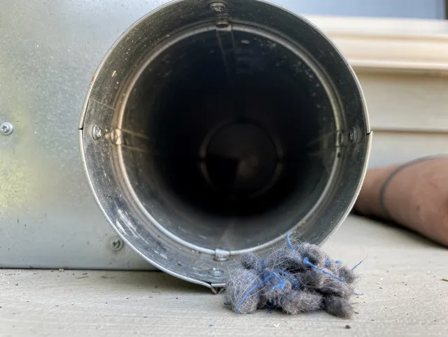 Sarasota Dryer Vent Cleaning technician using specialized equipment to clear severe dryer vent blockage in Sarasota
